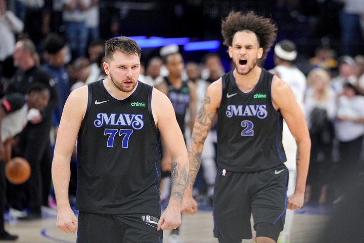 May 24, 2024; Minneapolis, Minnesota, USA; Dallas Mavericks guard Luka Doncic (77) and center Dereck Lively II (2) celebrate in the fourth quarter against the Minnesota Timberwolves in game two of the western conference finals for the 2024 NBA playoffs at Target Center. Mandatory Credit: Brad Rempel-USA TODAY Sports